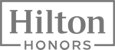 The image displays the Hilton Honors logo, with "Hilton" in large text and "Honors" below it in smaller text, both framed by lines.